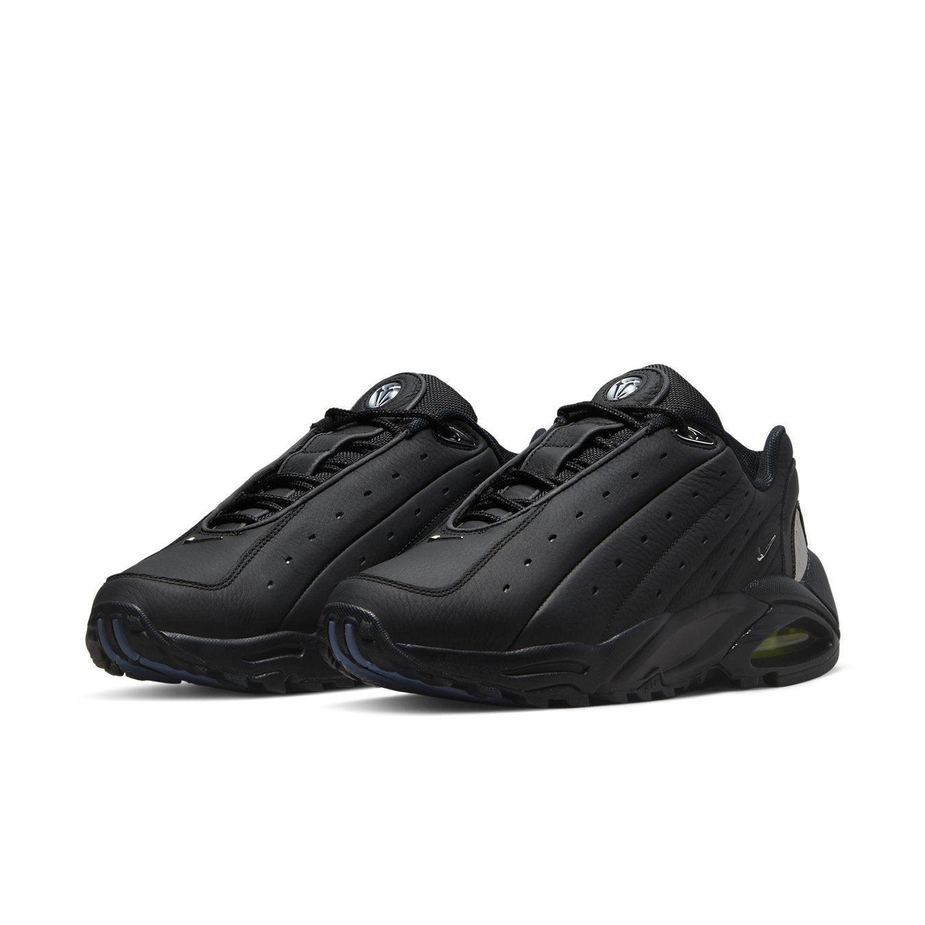 Nike Hot Step Air Terra Drake NOCTA Triple Black sneakers with leather upper and perforated details.