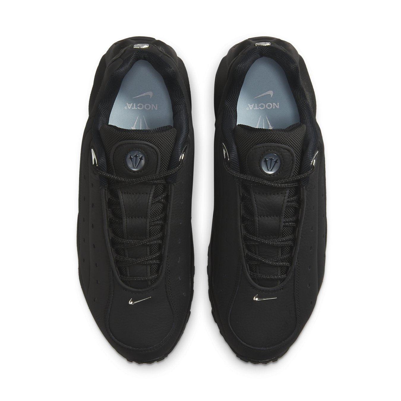 Nike Hot Step Air Terra Drake NOCTA sneakers in triple black with leather upper and decorative stitching.