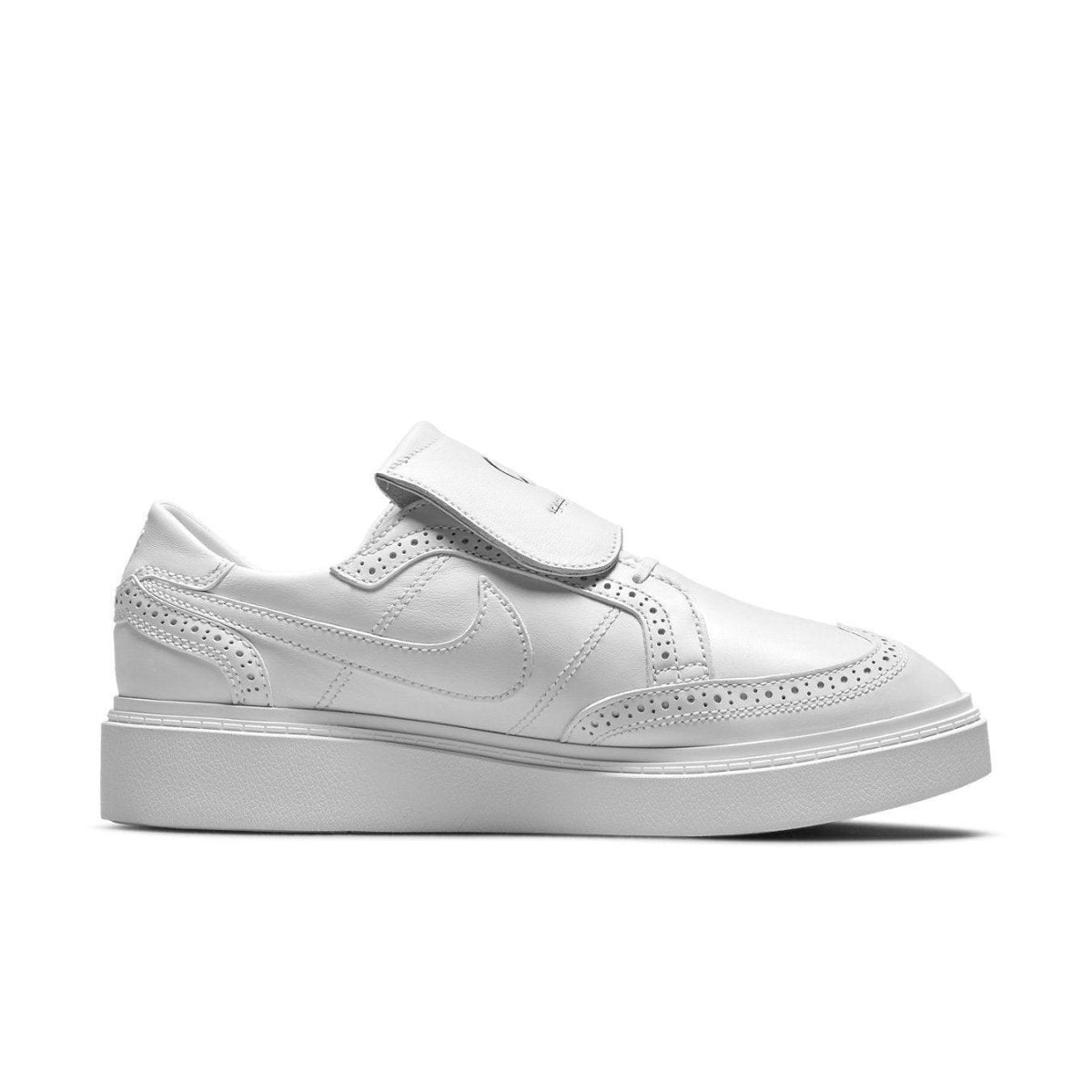 Nike Kwondo 1 G-Dragon Peaceminusone Triple White sneaker side view featuring white leather and brogue details.