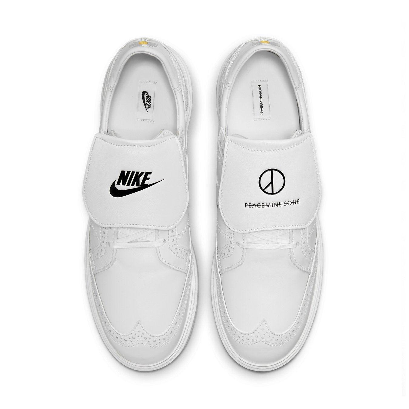 Nike Kwondo 1 G-Dragon Peaceminusone Triple White shoes with black branding on a white leather upper.