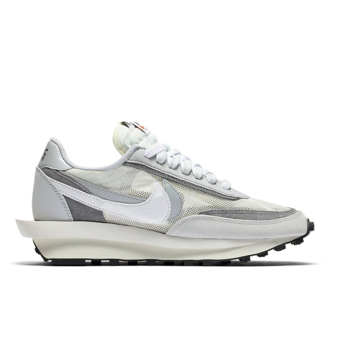 Nike LD Waffle Sacai Summit White sneaker in mesh and leather with dual Swoosh and laces, showcasing hybrid design.