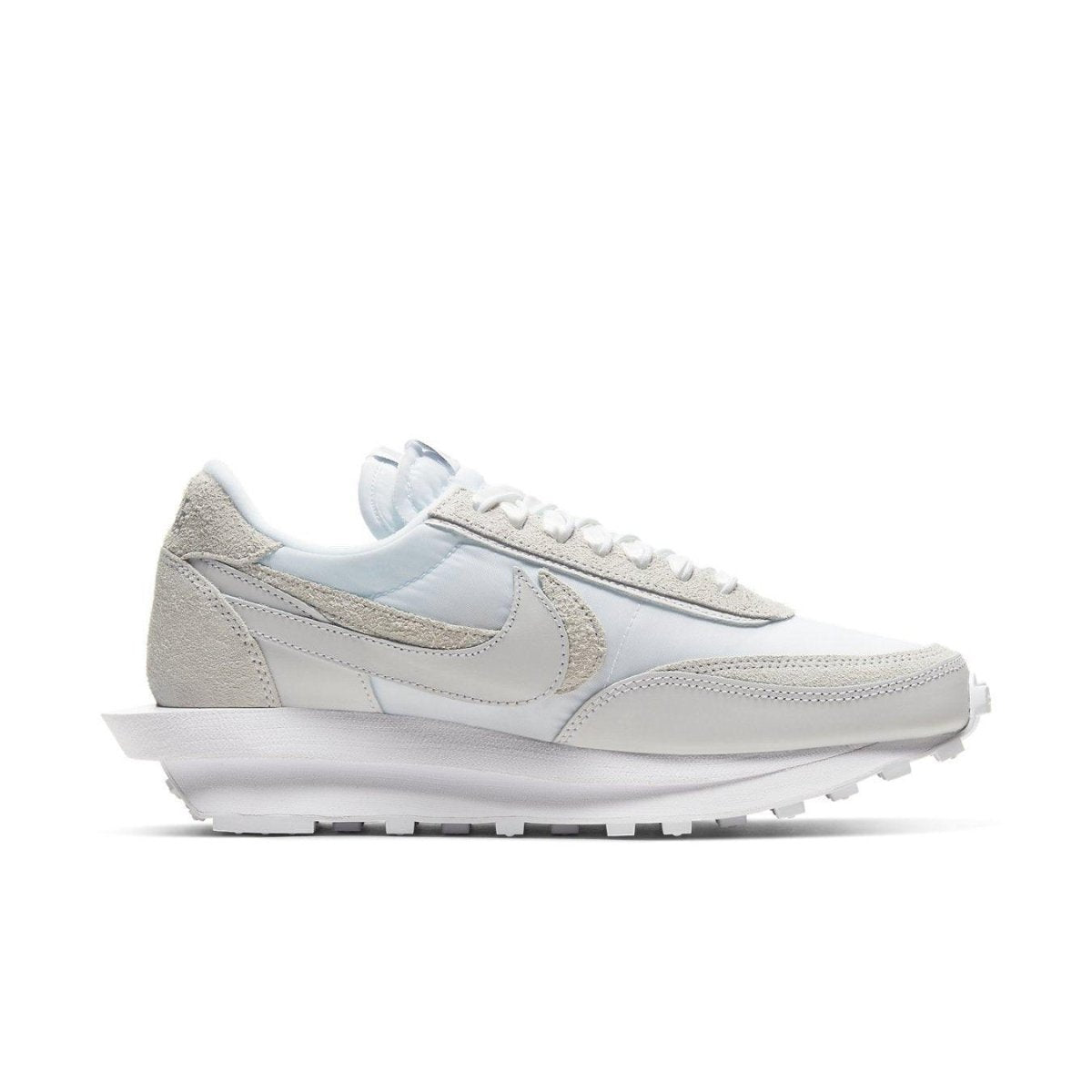 Nike LD Waffle Sacai sneakers in white nylon, featuring dual theme design and co-branded emblem with Sacai.