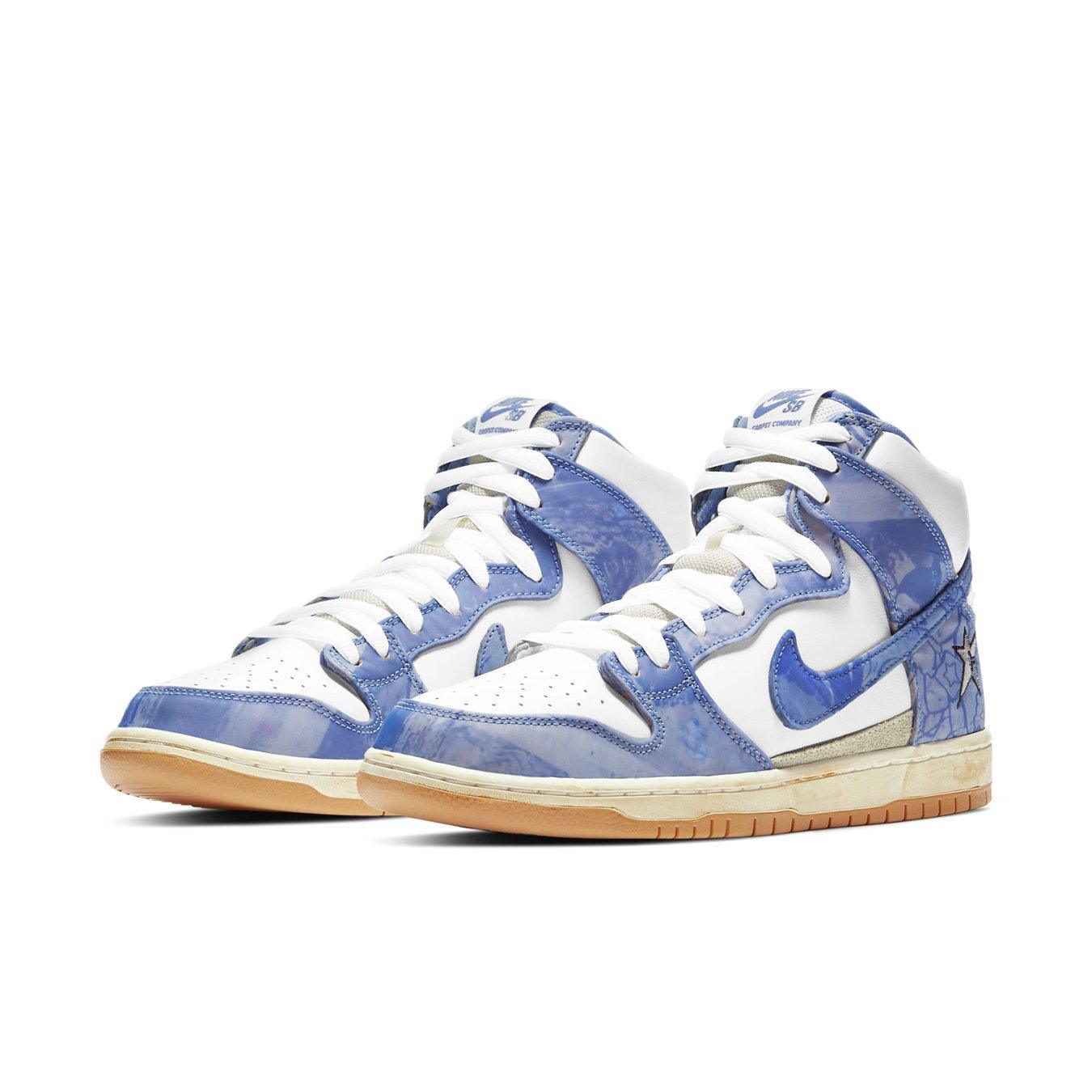 Nike SB Dunk High Carpet Company sneakers featuring white leather and blue patterned overlays.
