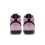 Nike SB Dunk High Pro KCDC in pink suede, featuring a black strap and gum sole, showcasing the back view.