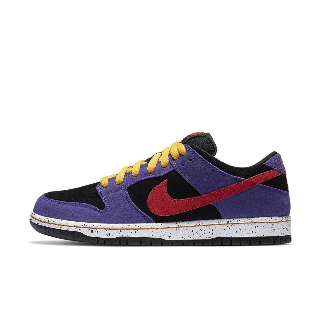 Nike SB Dunk Low ACG Terra sneakers in vibrant purple, black, and red with speckled midsole and yellow laces.