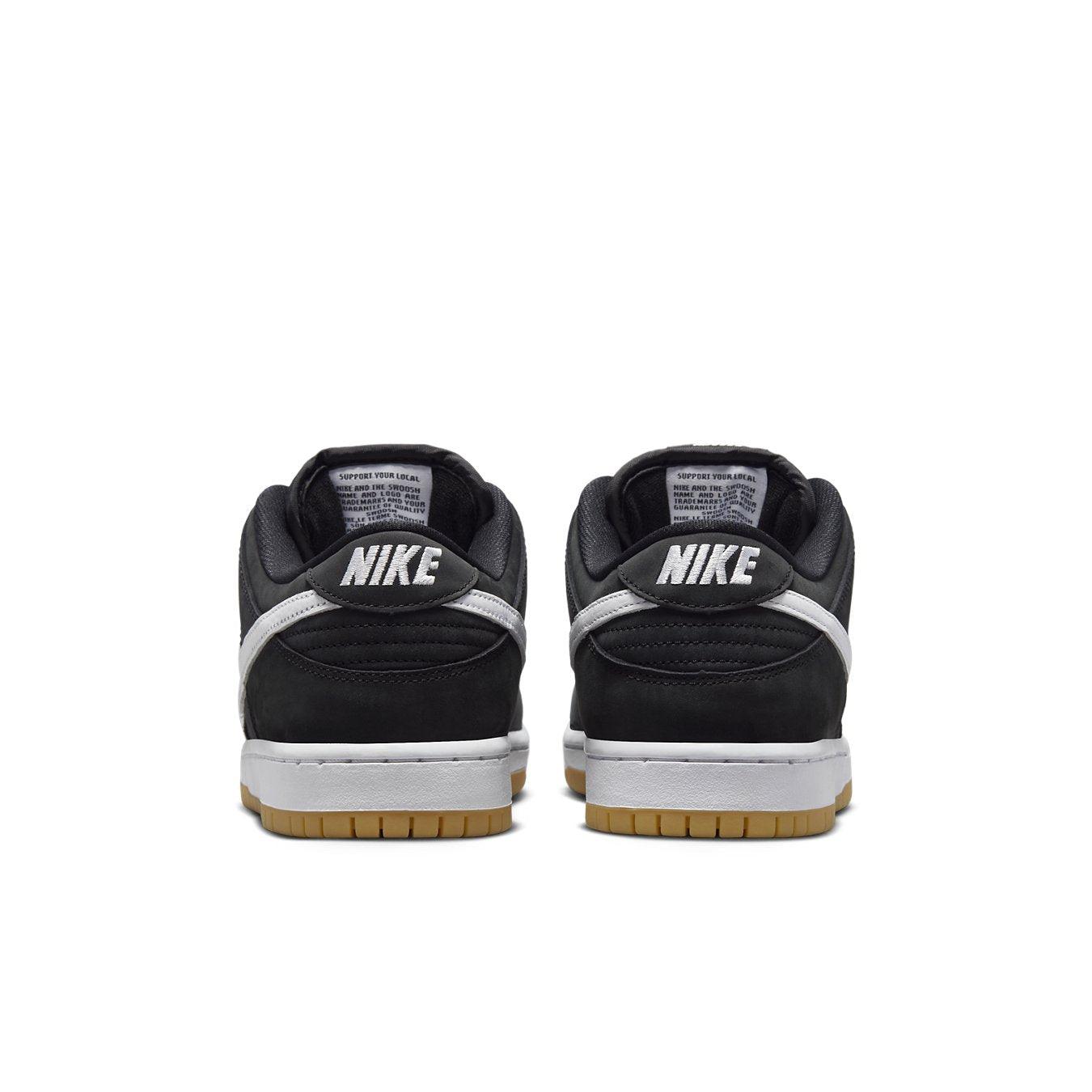 Nike SB Dunk Low Black Gum sneakers from the back showcasing black nubuck and white leather detailing.