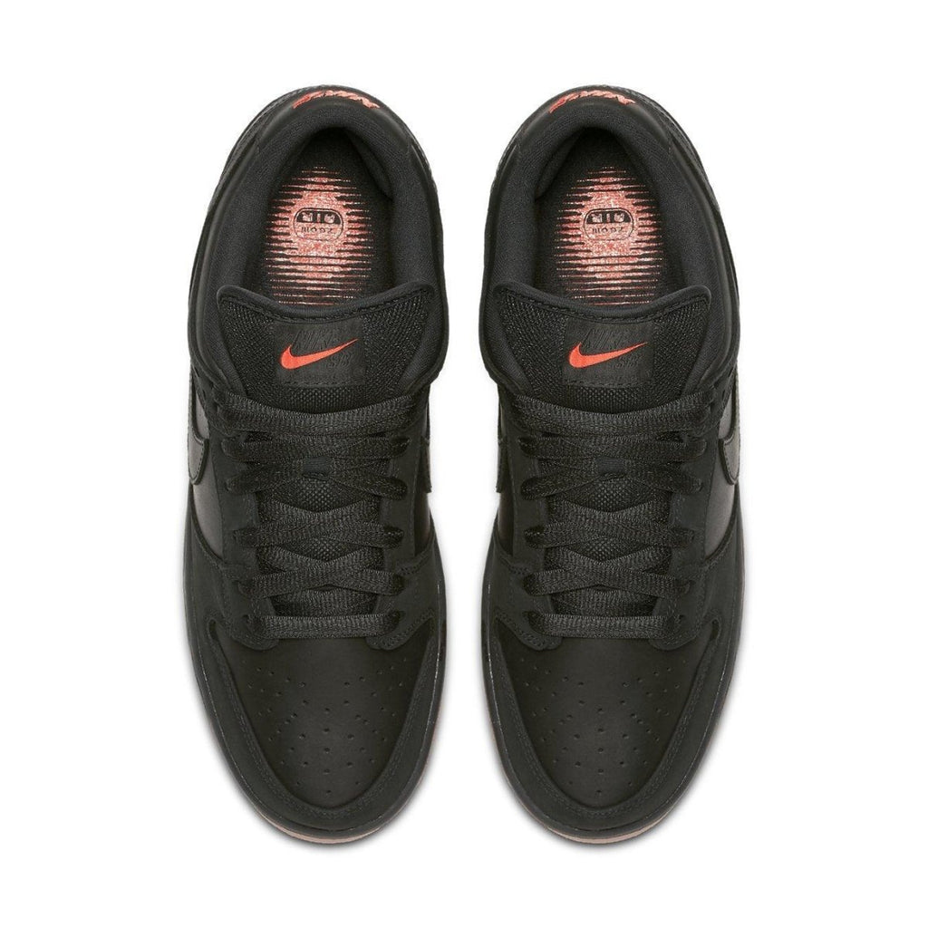 Nike SB Dunk Low Black Pigeon sneakers from above, featuring black leather and subtle orange accents.
