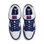 Nike SB Dunk Low in Deep Royal Blue and White with red accents on tongue and classic design.