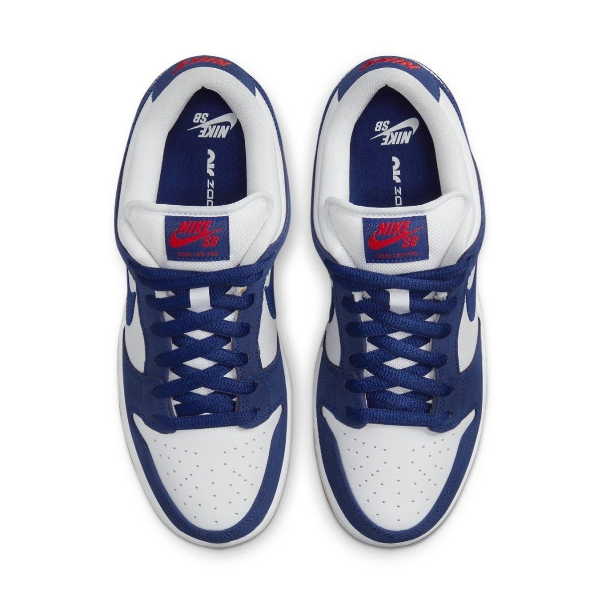 Nike SB Dunk Low in Deep Royal Blue and White with red accents on tongue and classic design.