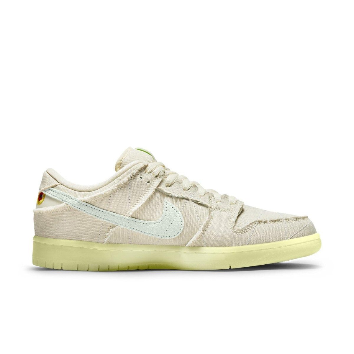 Nike SB Dunk Low 'Mummy' in white canvas with glow-in-the-dark outsole and irregular stitching for Halloween.