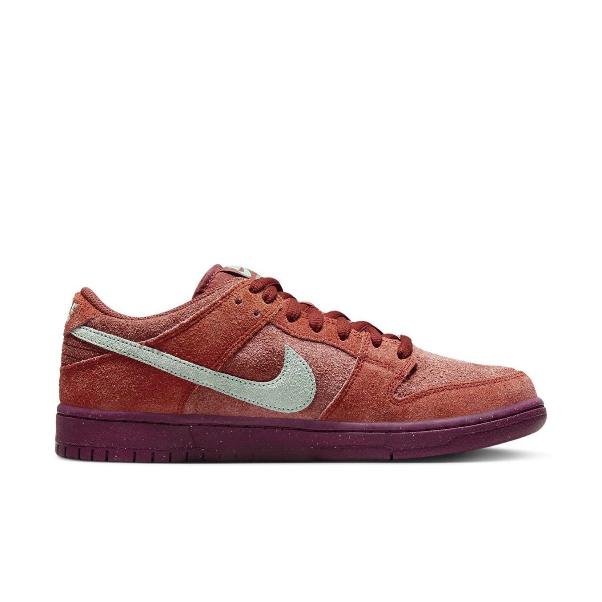 Nike SB Dunk Low Mystic Red in vibrant red suede with Emerald Rise accents and purple sole, showcasing sleek style.