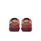 Rear view of Nike SB Dunk Low Mystic Red with Emerald Rise accents and logo detailing.