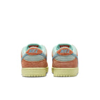 Rear view of Nike SB Dunk Low Orange Emerald Rise, featuring vibrant orange and emerald suede details.