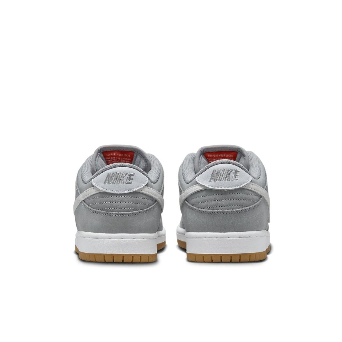 Rear view of Nike SB Dunk Low Pro ISO 'Wolf Grey Gum' sneakers showcasing grey suede upper and gum outsole.