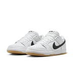 Nike SB Dunk Low Pro in white leather with black Swoosh and gum sole, offering a premium low-top sneaker style.