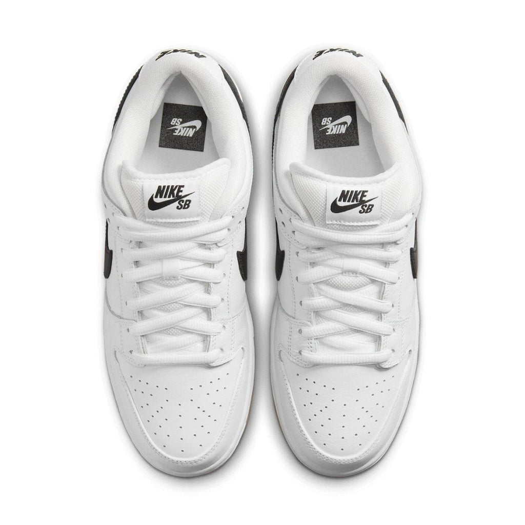 Nike SB Dunk Low Pro in white with black Swoosh, featuring a low-cut design and premium leather.