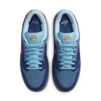 Nike SB Dunk Low Run The Jewels collaboration sneaker with blue suede upper and pink Swoosh detail.