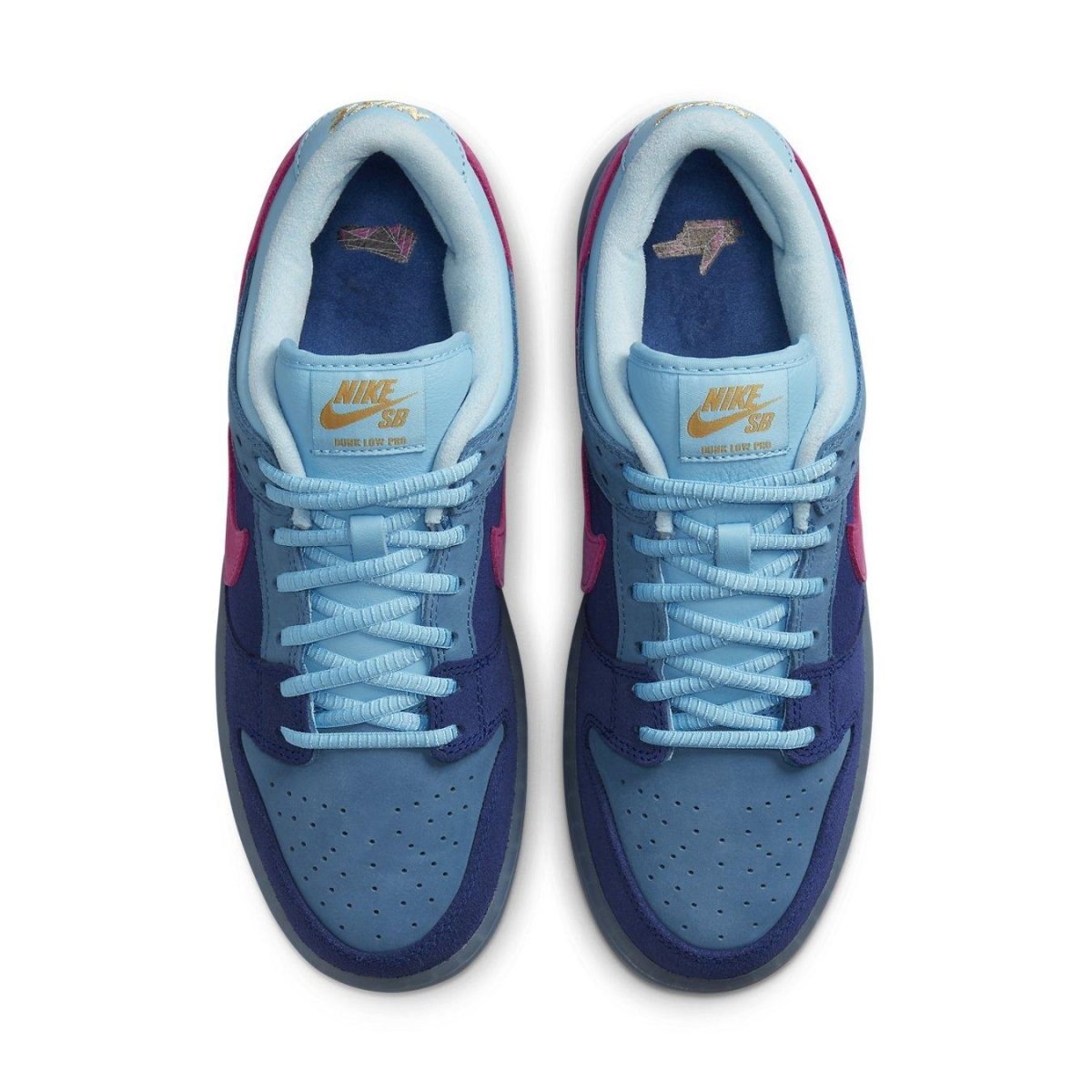 Nike SB Dunk Low Run The Jewels collaboration sneaker with blue suede upper and pink Swoosh detail.