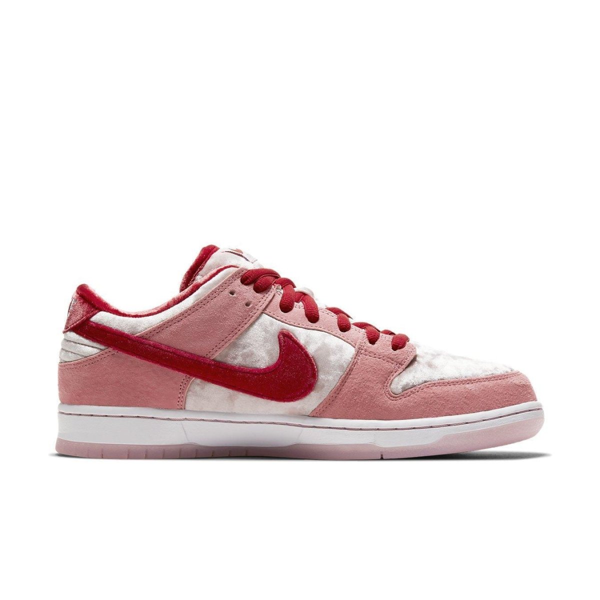Nike SB Dunk Low StrangeLove Skateboards in pink and red with textured velvet and suede overlays.