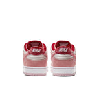 Nike SB Dunk Low StrangeLove Skateboards rear view showing pink and red colorway with velvet and suede textures.