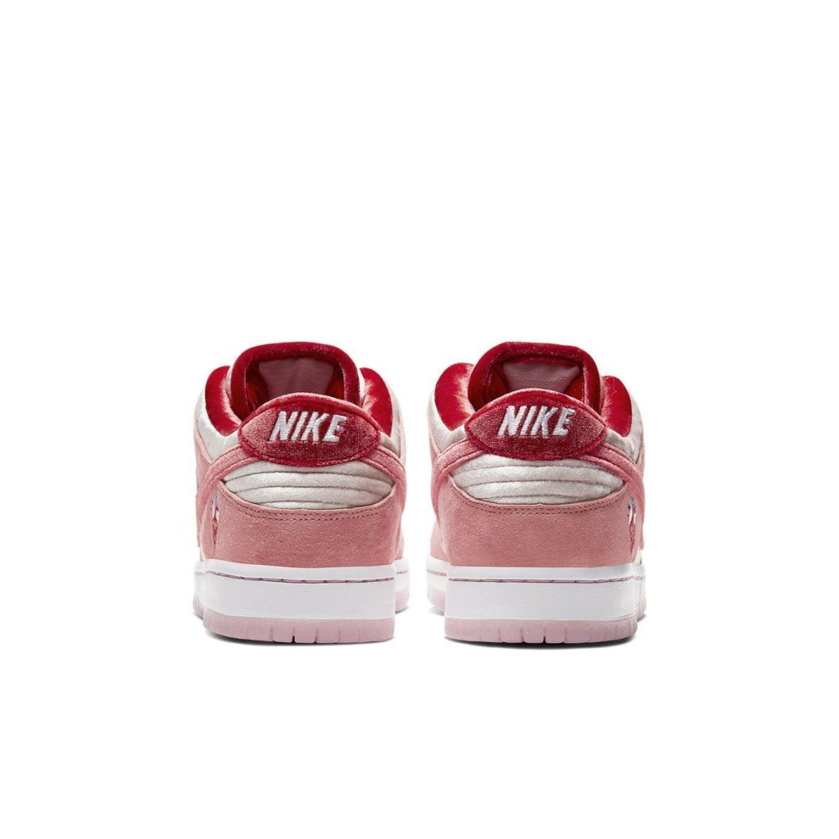 Nike SB Dunk Low StrangeLove Skateboards rear view showing pink and red colorway with velvet and suede textures.