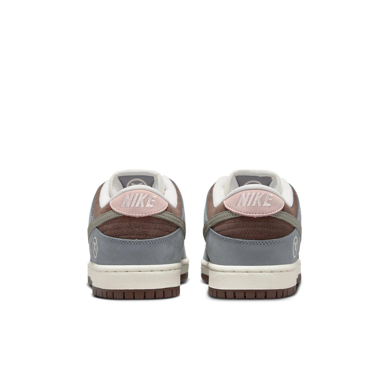 Nike SB Dunk Low Yuto Horigome sneakers featuring gray and pink accents on the heel and a classic silhouette.