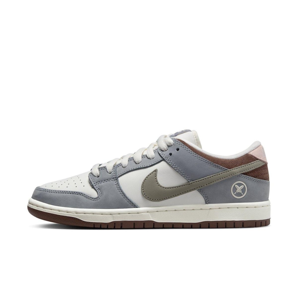 Nike SB Dunk Low Yuto Horigome in white leather and grey suede, featuring a distinctive Swoosh and unique design details.