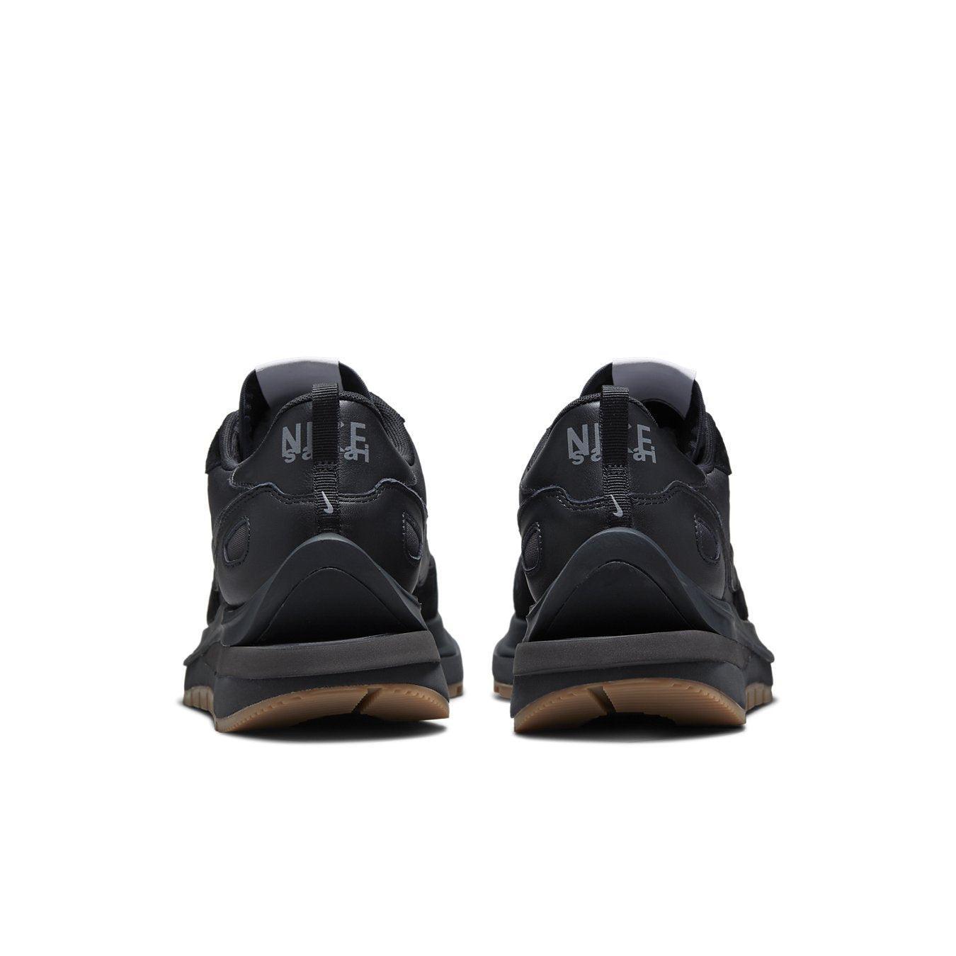 Back view of Nike Vaporwaffle sacai Black Gum sneakers featuring a black nylon upper and gum sole.