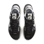 Top view of Nike VaporWaffle sacai sneakers in black and white with double laces and logo detail.