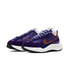 Nike Vaporwaffle sacai Dark Iris sneakers featuring purple nylon upper and orange accents.