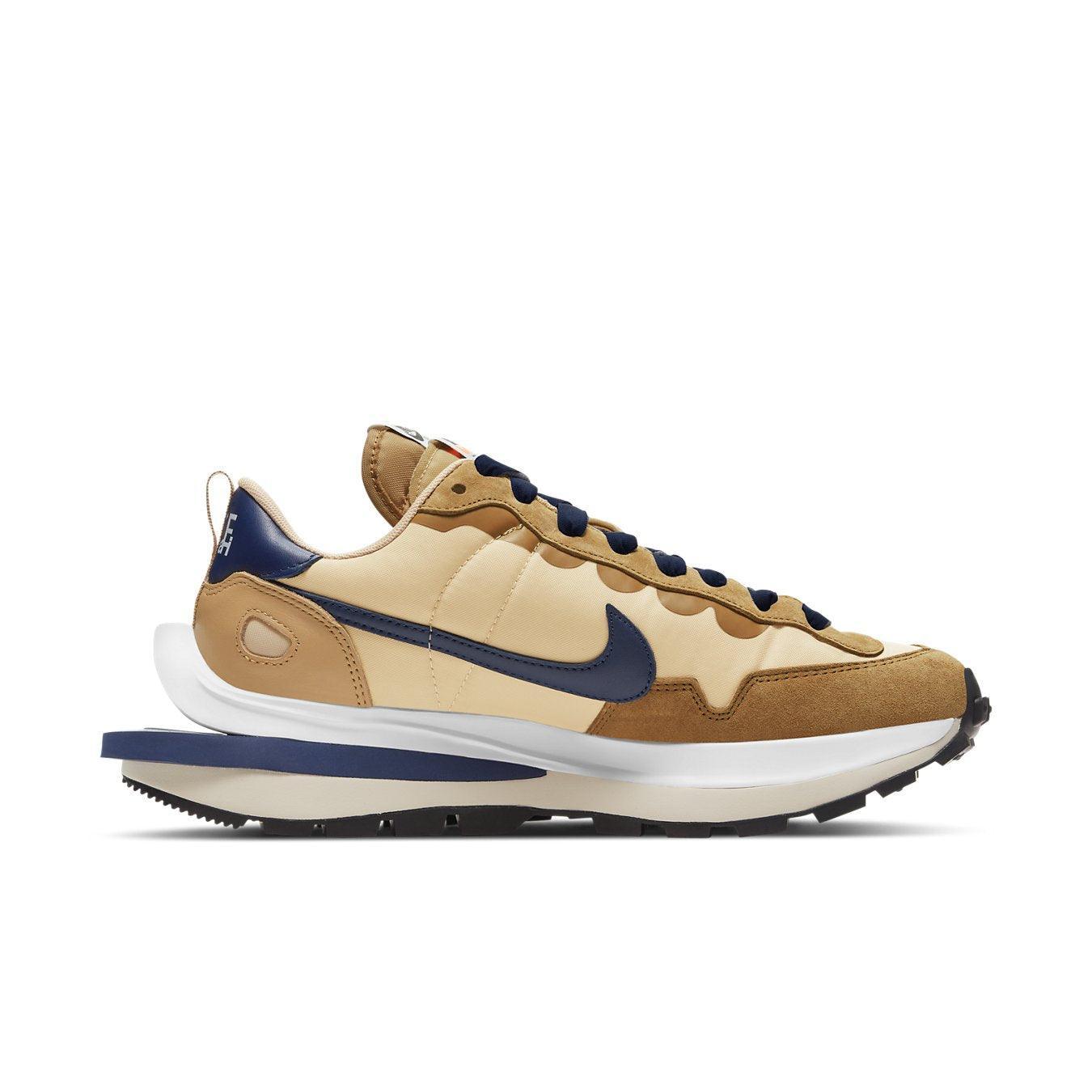 Nike Vaporwaffle sacai in Sesame and Blue Void featuring a blend of modern and classic running shoe design.