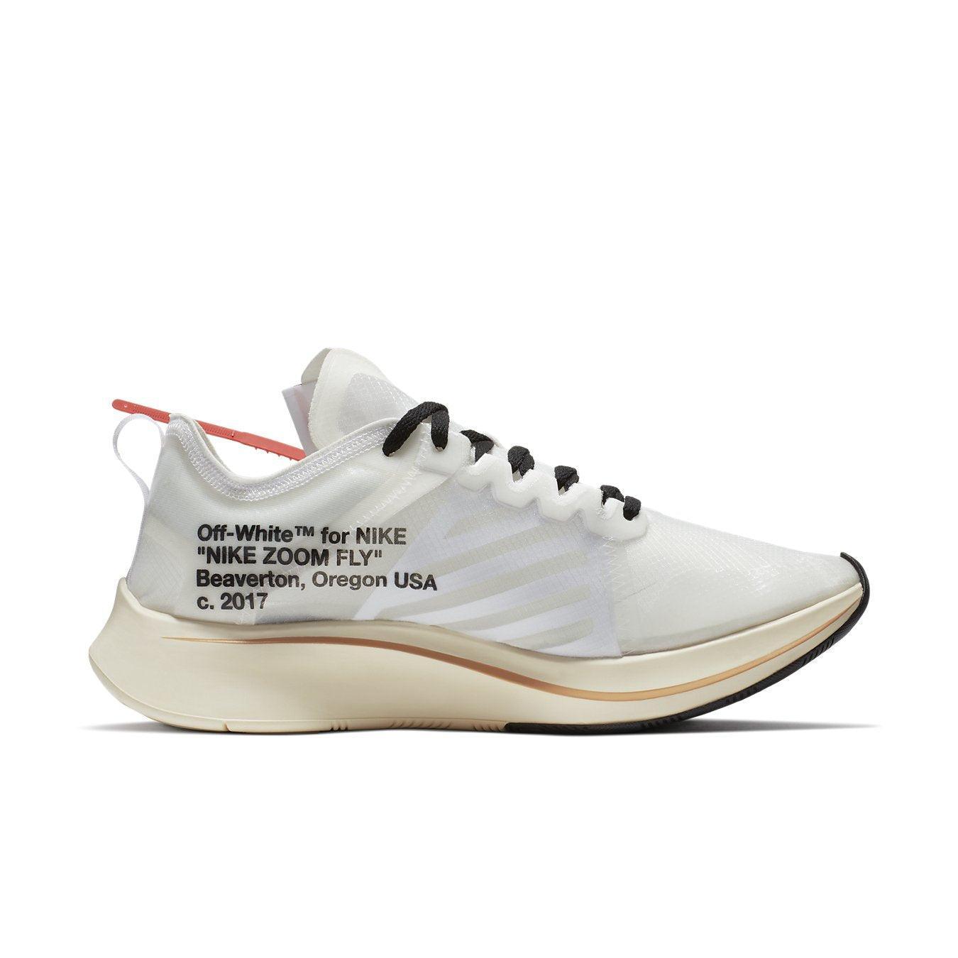 Nike Zoom Fly Off-White sneakers with white upper, orange accents, and signature detailing in a side view.
